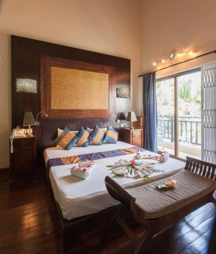 Ένα ή περισσότερα κρεβάτια σε δωμάτιο στο Le Relax Beach House