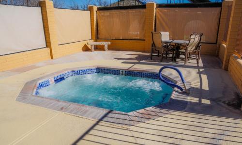 a swimming pool on a patio with a table and chairs at Verde Valley One-Bedroom Park Model Cabin 14 in Cottonwood