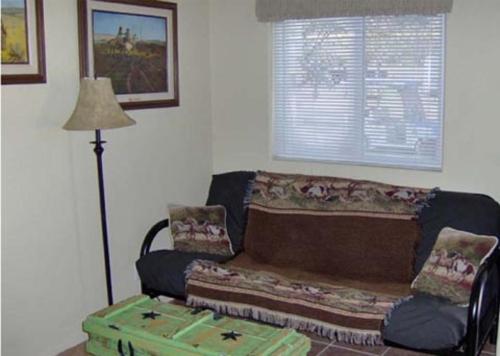 a living room with a couch and a table at Verde Valley Studio Park Model Cabin 16 in Cottonwood
