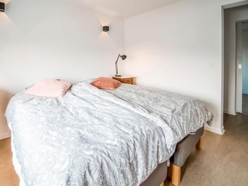 a bedroom with a bed with pink pillows on it at Holiday home in HUY near town center in Huy