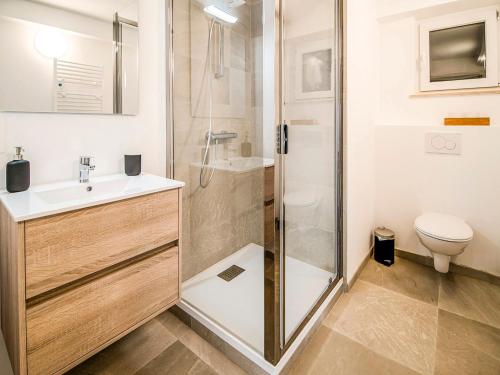 a bathroom with a shower and a sink and a toilet at Holiday home in HUY near town center in Huy