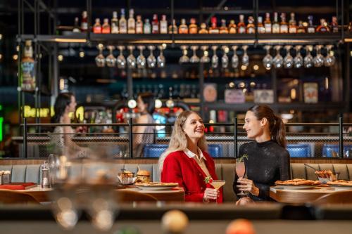 two women sitting at a table in a restaurant at Four Points by Sheraton Bangkok, Sukhumvit 22 in Bangkok