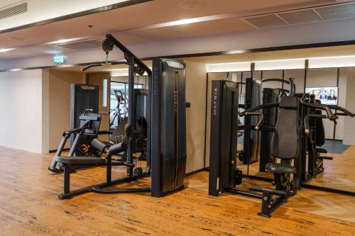 a gym with several tread machines in a room at Four Points by Sheraton Bangkok, Sukhumvit 22 in Bangkok