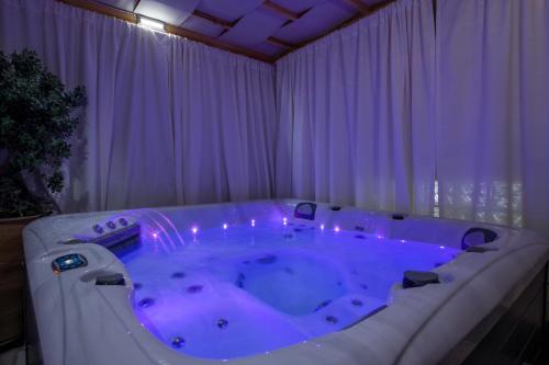 a large tub in a room with purple lighting at Lucky Suites in Rethymno Town
