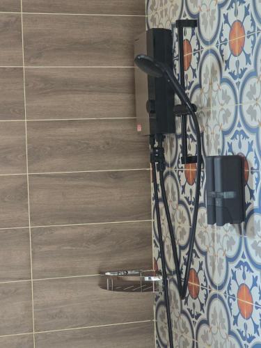 a shower in a bathroom with a tile wall at White Beach Resort Longset in Koh Rong Island