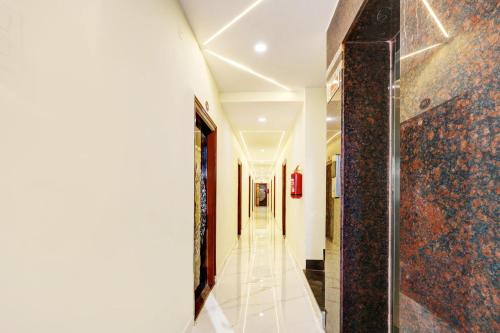 a hallway with a tile floor and a glass door at Super Hotel O Vizianagaram Near Railway Station in Vizianagram City