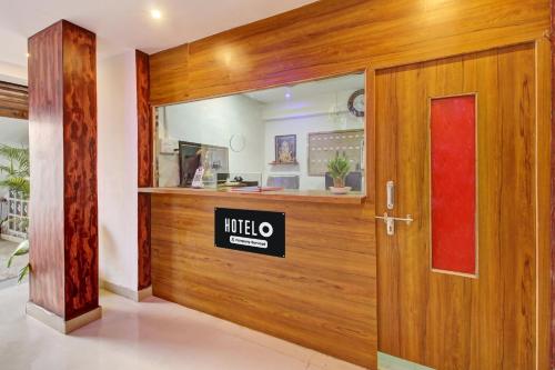 a wooden door with a mitzo sign on it at Hotel O Bhekrai Nagar Bus Terminal Formerly Silver Star in Phūrsungi