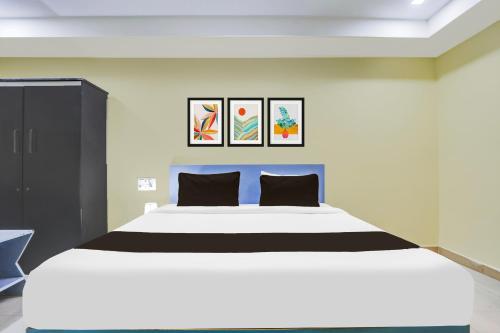 a bedroom with a large white bed with two pillows at Collection O Nellore Subbareddy Government Hospital Formerly Hotel Rama Royal in Nellore