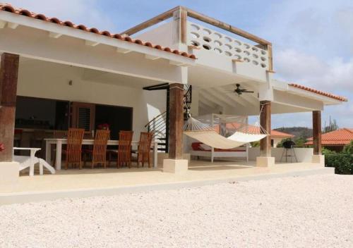 a villa on the beach with a patio at Villa Caribbean Dream Bonaire in Kralendijk