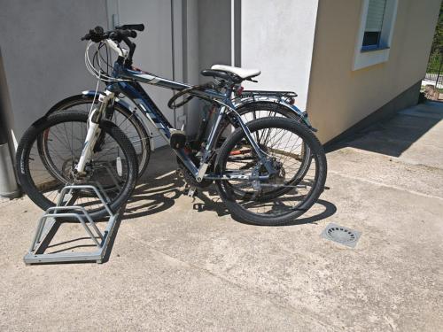 a bike parked on a stand next to a building at Holiday House Provance in Brod na Kupi