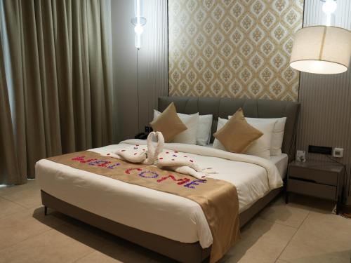 a bedroom with a bed with a stuffed animal on it at Sportico Resort Bangalore in Mālūr