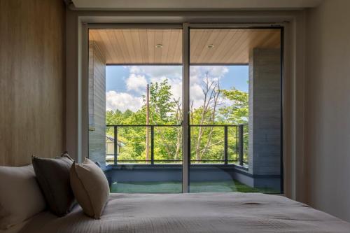 Ένα ή περισσότερα κρεβάτια σε δωμάτιο στο Hours Villa 富嶺