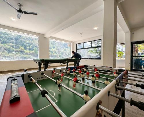 a man in a room with a pool table at Euphoric Resort ,Mohanchatti in Rishīkesh