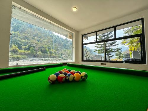 a room with a pool table with balls on it at Euphoric Resort ,Mohanchatti in Rishīkesh
