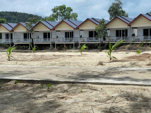 a row of houses with red roof at White Beach Resort Longset in Koh Rong Island