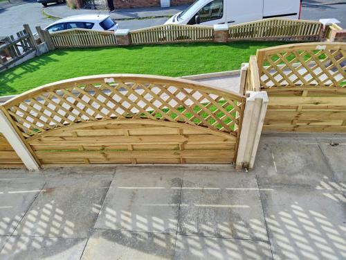 a wooden bench sitting on the side of a sidewalk at Barnsley cozy home 