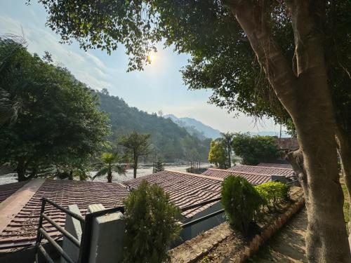 a view of the roof of a house with a river at Euphoric Resort ,Mohanchatti in Rishīkesh