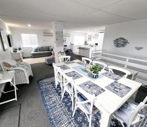 a living room with a white table and chairs at Hamptons in Lancelin