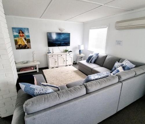 a living room with a couch and a tv at Hamptons in Lancelin