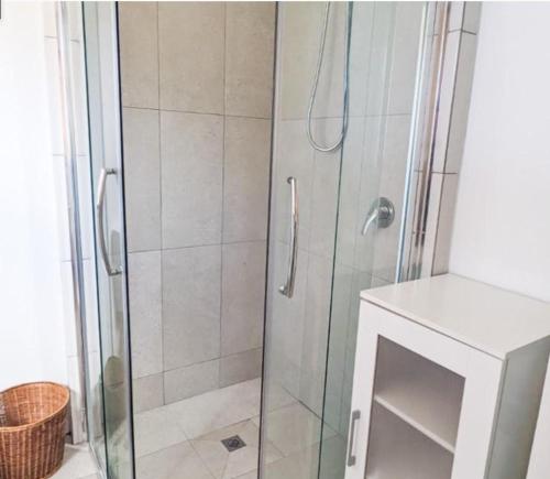 a shower with a glass door in a bathroom at Double View in Lancelin
