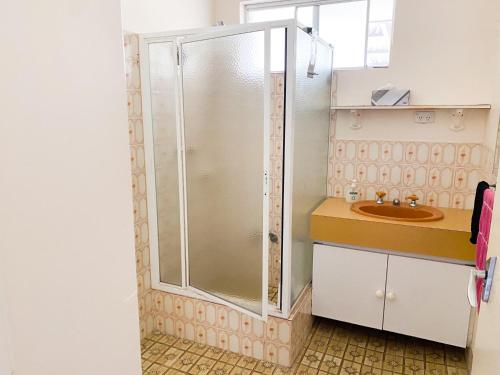 a bathroom with a shower and a sink at Lancelin Beach house in Lancelin