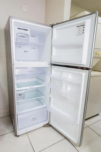 an empty refrigerator with its door open in a kitchen at Lodging centrally located near H.Civil, CUCS, IMSS in Guadalajara