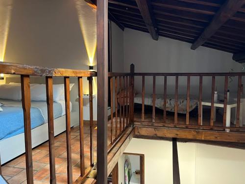 a room with a staircase with a bed in it at Le mie origini in Bagnoregio