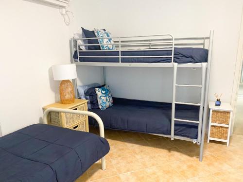 a bedroom with two bunk beds and a bed at Ocean Spray in Lancelin