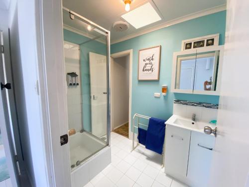 a bathroom with a shower and a sink at Ocean Spray in Lancelin