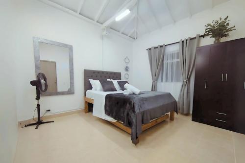 a bedroom with a large bed and a mirror at Modern & Central Dining & Nightlife in Estación El Salto