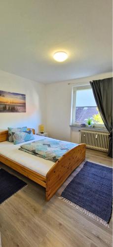 a large bed in a bedroom with a large window at Seeromantik in Amelinghausen