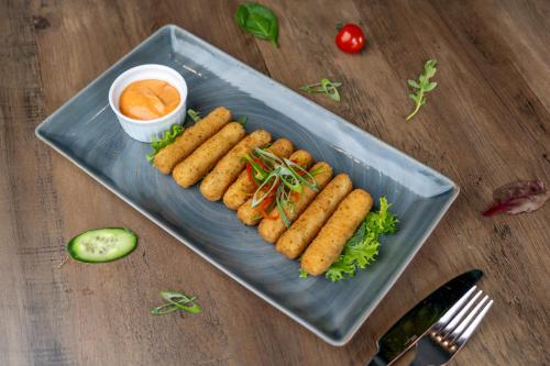 a plate of food with carrots on a table at VOGO Grand Hotel Formerly Best Western Plus Hotel Dubai Academic City in Dubai