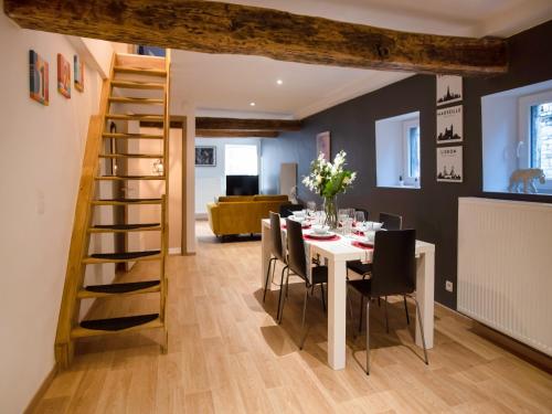 a dining room with a white table and chairs at Holiday home in the centre of Aywaille in Aywaille