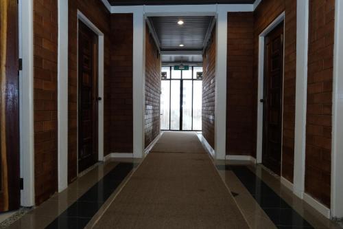 an empty hallway in a building with a door at OYO 1017 Al-inshirah Inn in Kota Bharu