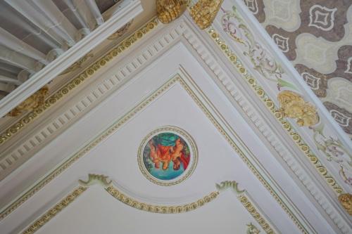 a ceiling of a building with a painting on it at Nizami Hotel Baku in Baku