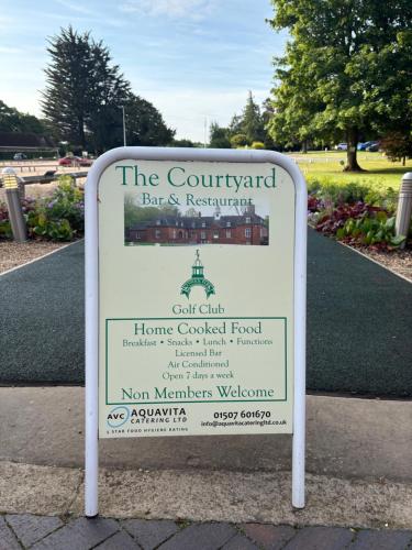 a sign for the courtyard bar and restaurant in a park at The Bunker in Legbourne