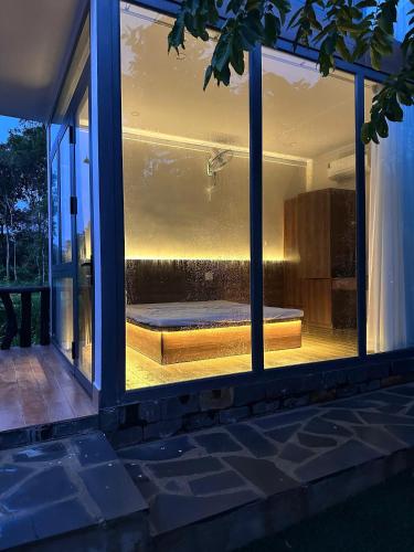 a window of a house with a bed in it at Homestay Dat Viet in Tân Phú
