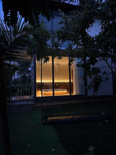 a room with a large window at night at Homestay Dat Viet in Tân Phú