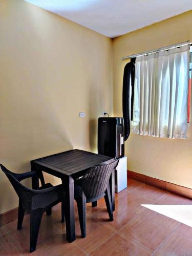 a black table and a chair in a room at La Ruta in Paracas