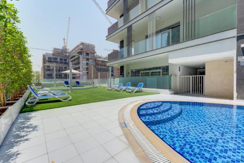 a swimming pool in the backyard of a building at 151 Residence Jumeirah Gardens in Dubai