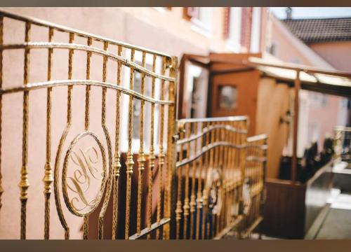 a wrought iron fence next to a building at Hotel luzern engel-Pilatus in Hitzkirch