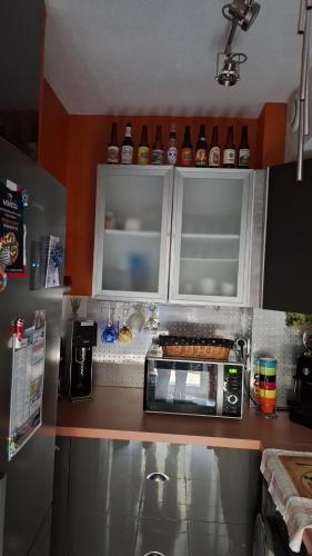 a kitchen with a counter top with a microwave at Comme en famille in Saint-Raphaël