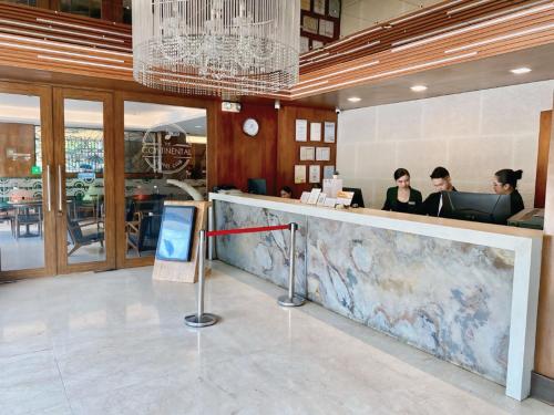 three women sitting at a counter in a restaurant at Castle Peak Hotel in Cebu City