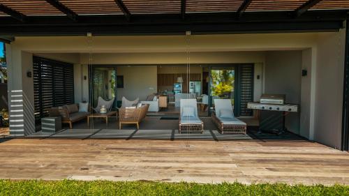 an outdoor patio with chairs and a pool table at Blue Nest by Horizon Holidays in Pointe d'Esny
