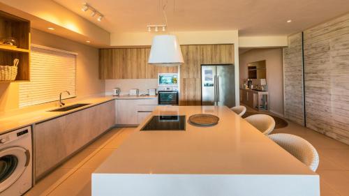 a kitchen with a sink and a counter top at Blue Nest by Horizon Holidays in Pointe d'Esny