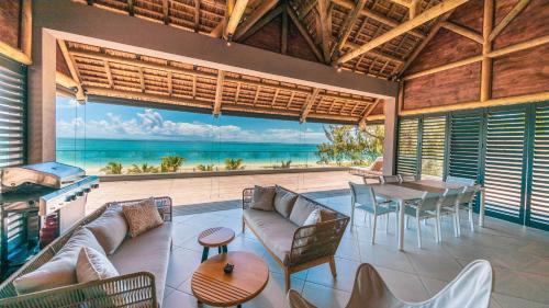 a living room with a view of the ocean at Blue Nest by Horizon Holidays in Pointe d'Esny