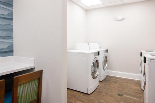 a white laundry room with a washer and dryer at Hampton Inn & Suites Jekyll Island in Jekyll Island