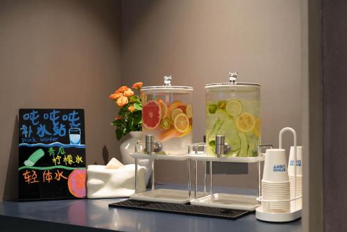 a counter with two glass containers with fruit in it at Atour Light Hotel Beijing Wukesong 301 PLA Hospital in Beijing