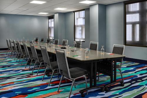 a conference room with a long table and chairs at the Curtis Denver - A DoubleTree by Hilton Hotel in Denver