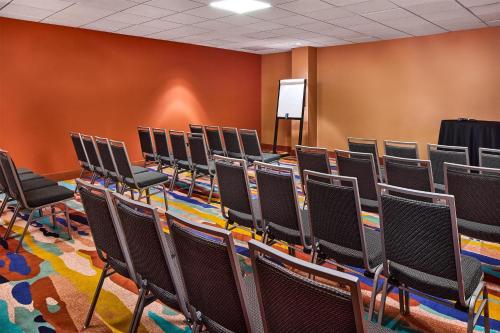 an empty lecture room with chairs and a podium at the Curtis Denver - A DoubleTree by Hilton Hotel in Denver